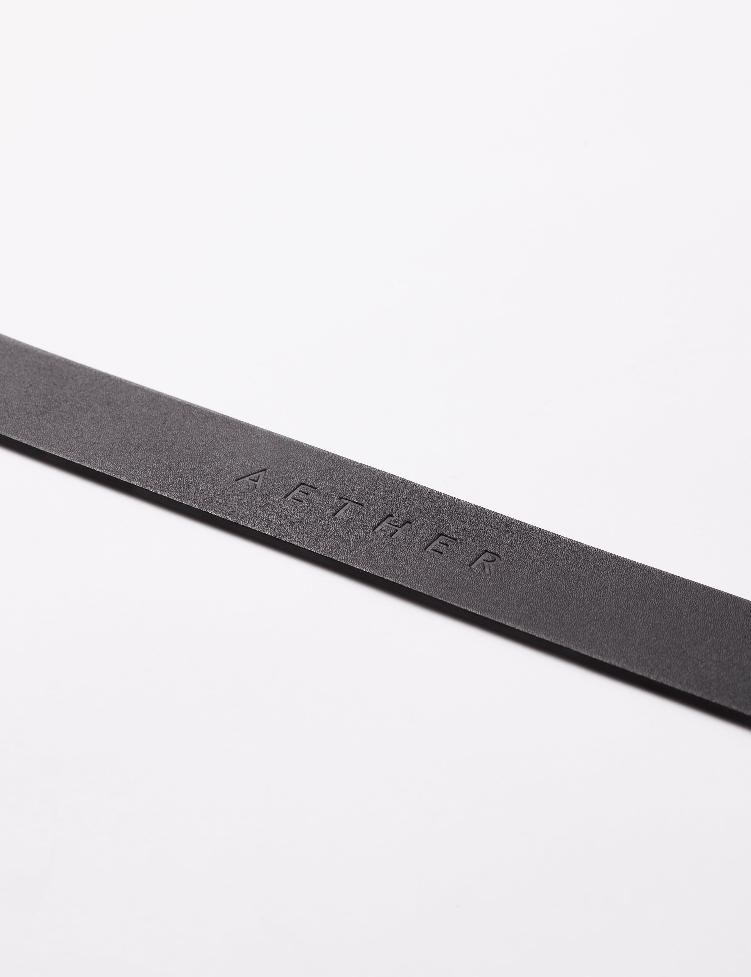 AETHER logo on strap of black Canyon Leather Belt from AETHER Apparel.