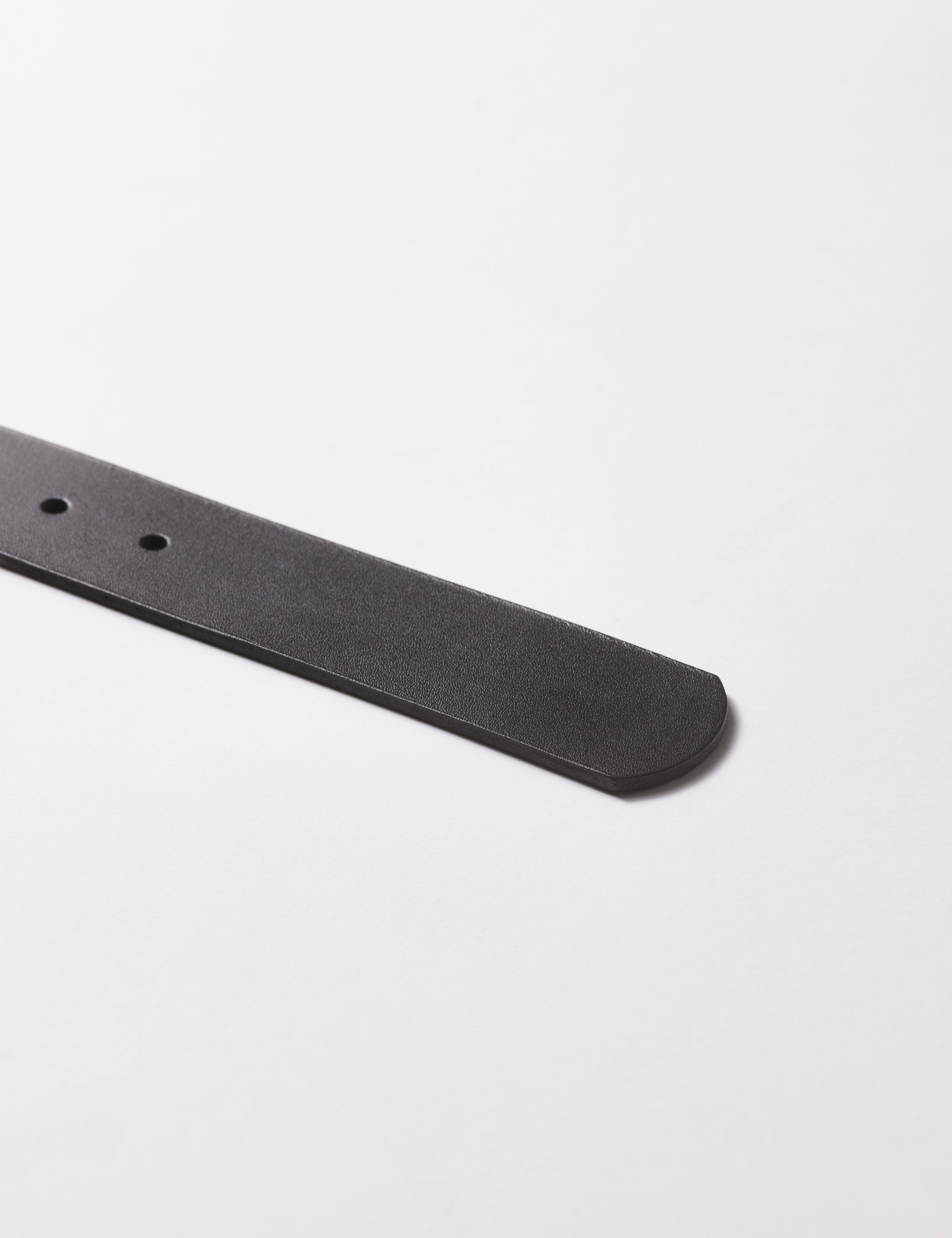End tip of black Canyon Leather Belt from AETHER Apparel.