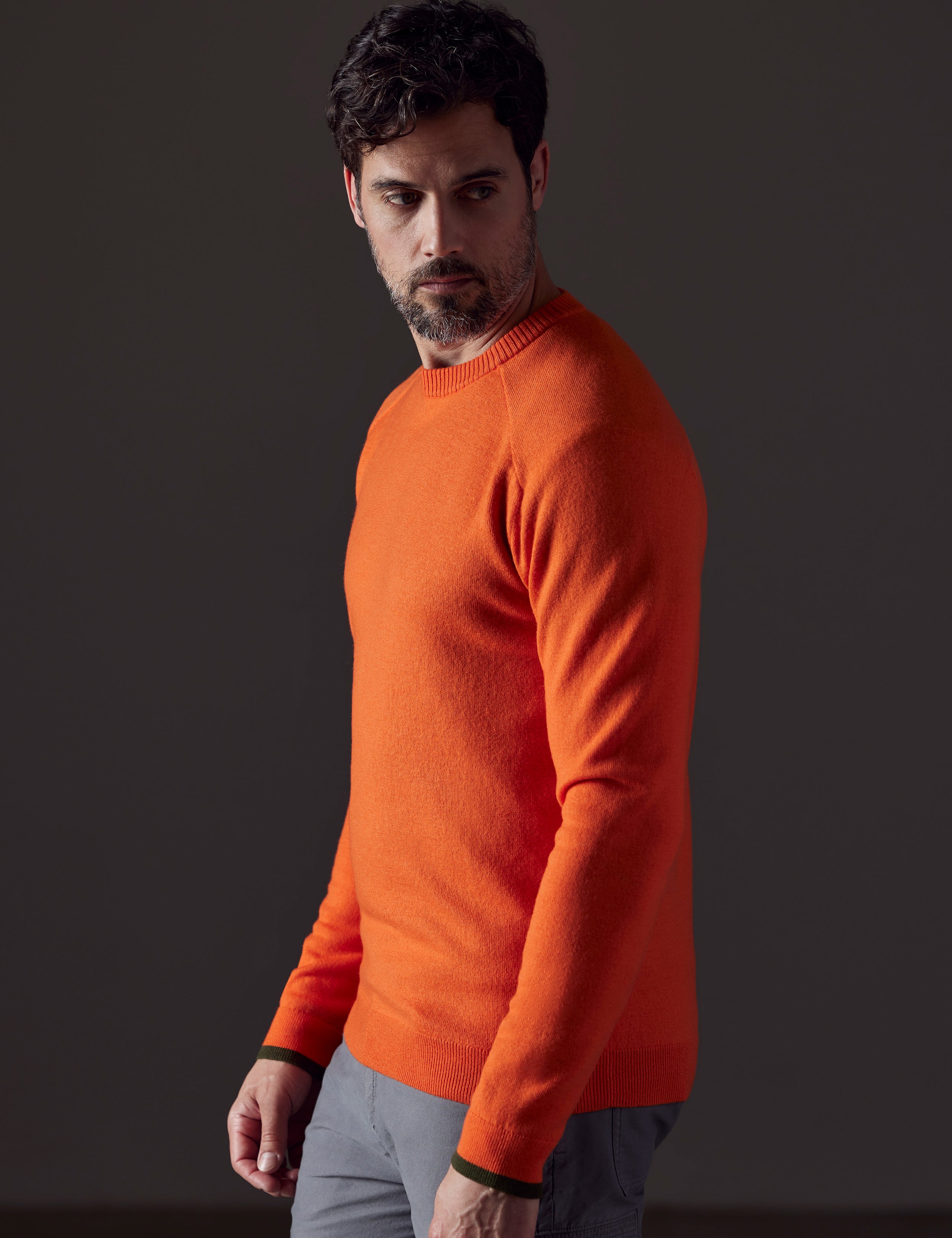 Side profile body view of man wearing Corbin Sweater in Sedona Orange from AETHER Apparel.