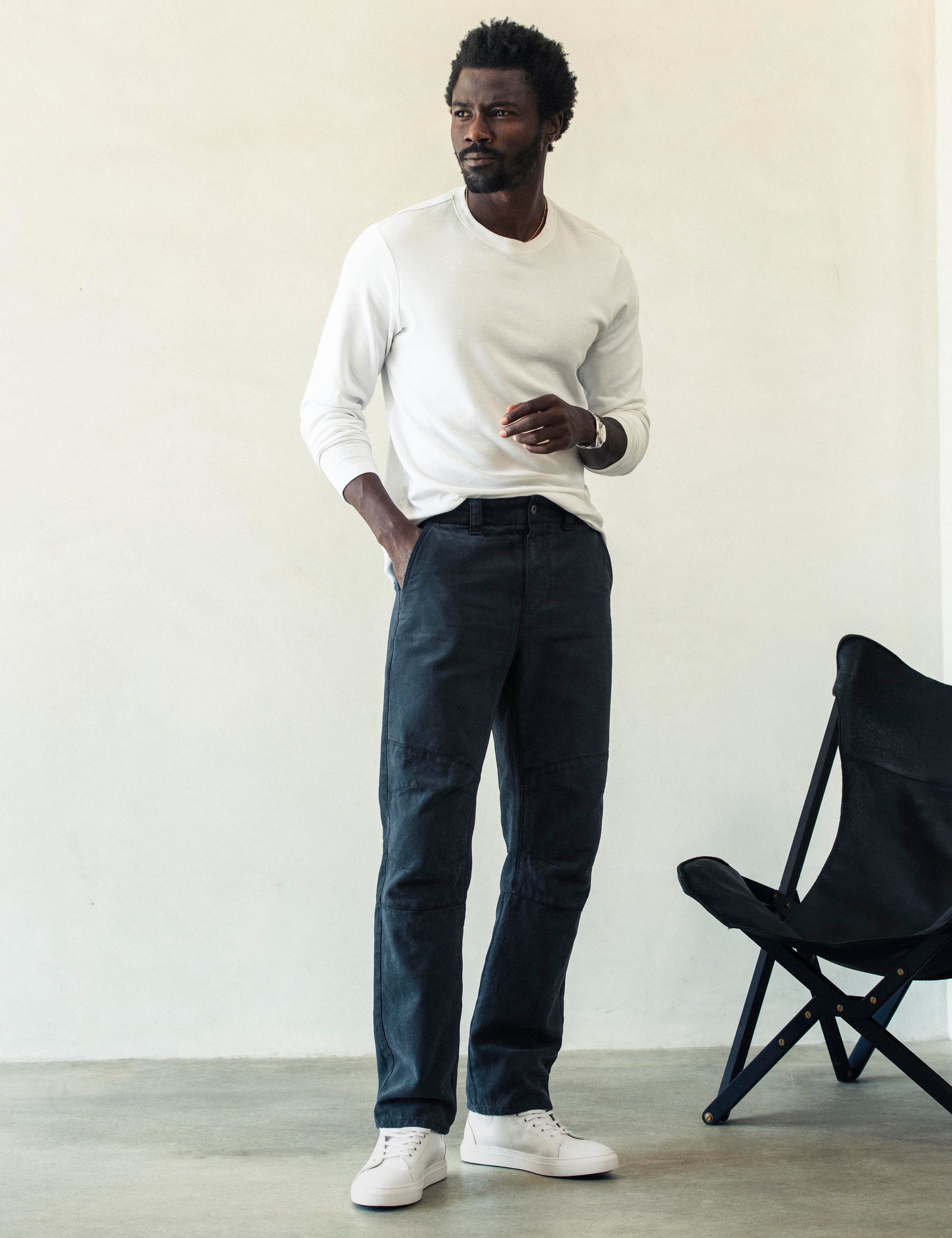 Front full-body view of man wearing Gabriel Articulated Chino Stretch pant in Total Eclipse dark blue from AETHER Apparel.