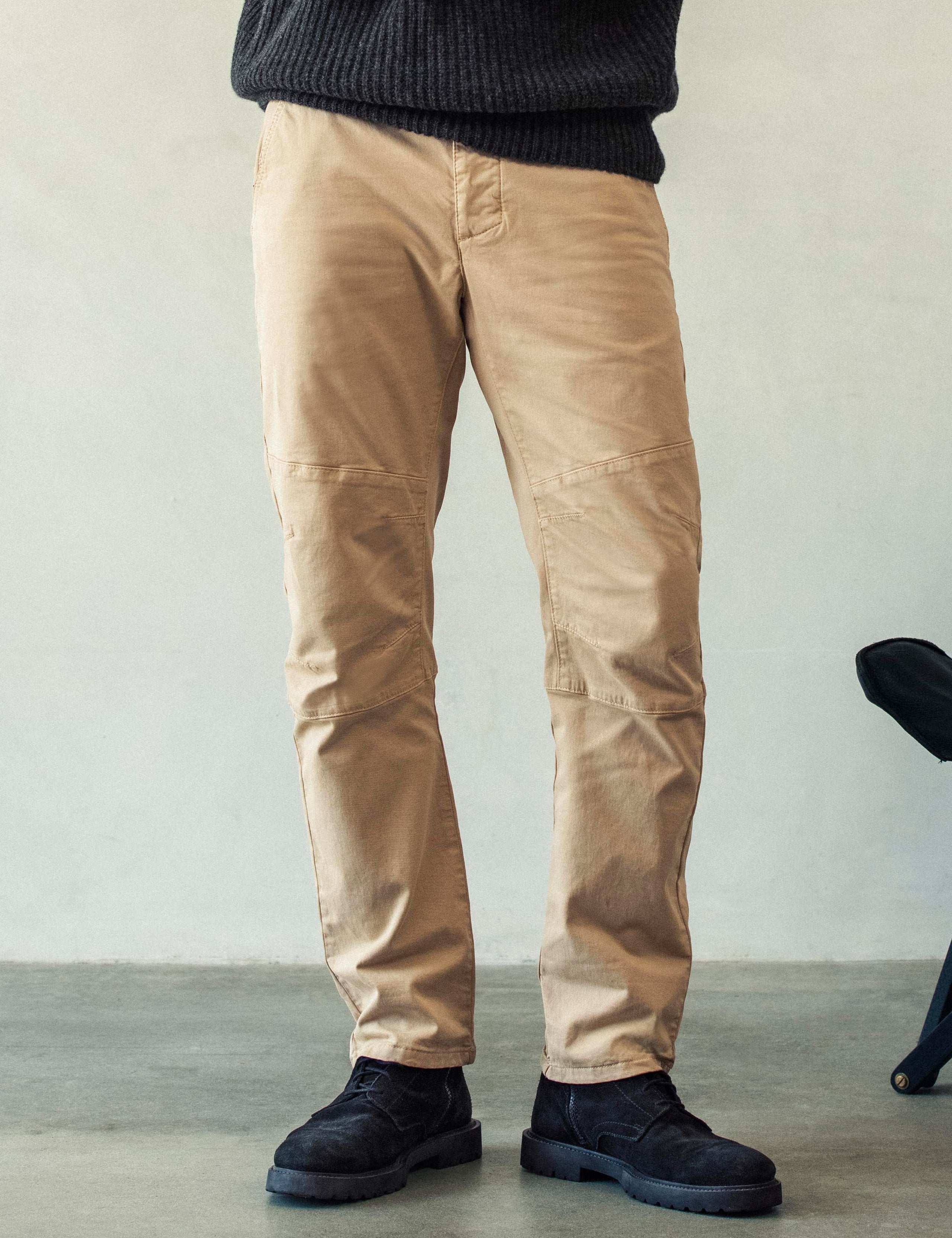 Front lower body view of man wearing Gabriel Articulated Chino Stretch pant in Desert Tan from AETHER Apparel.