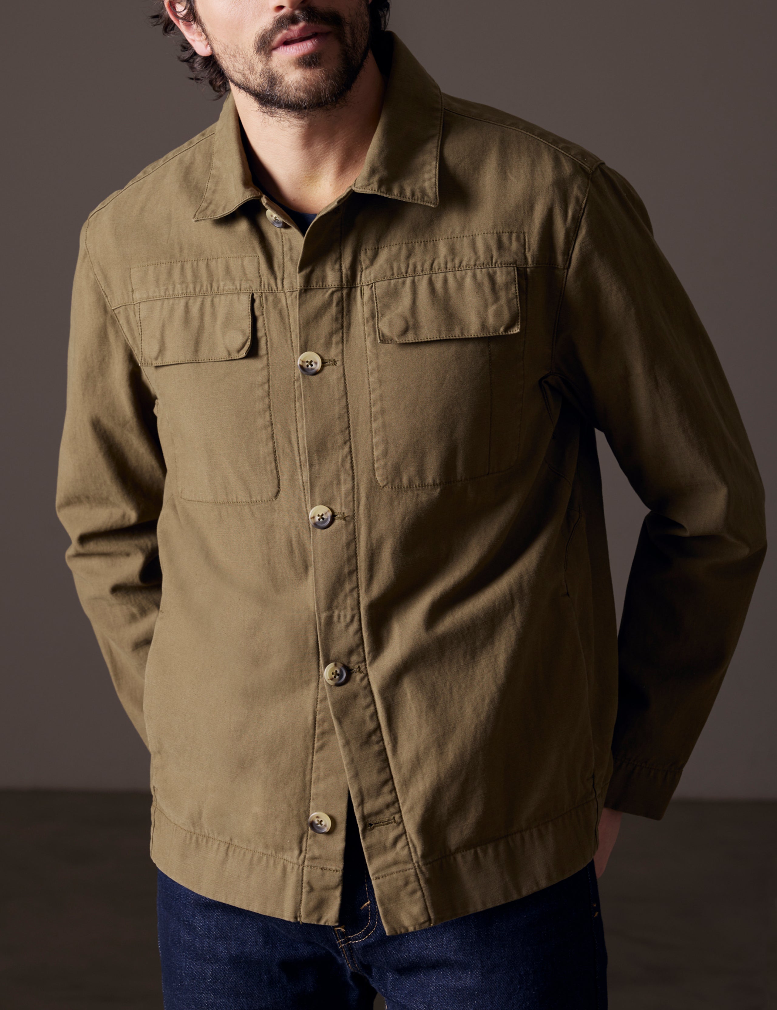 Front body view of man wearing Mesa Jacket in Command Green from AETHER Apparel.