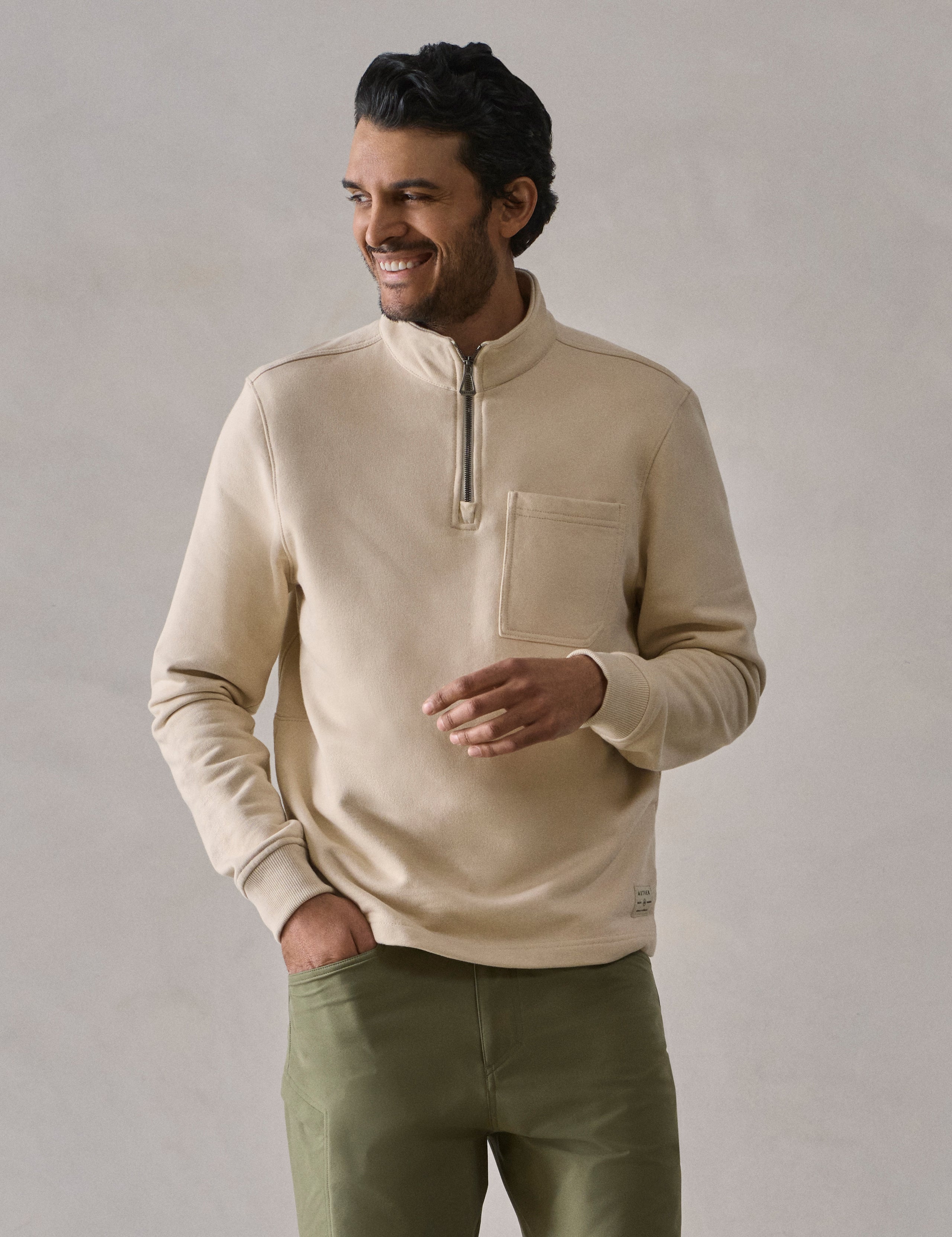 Front body view of man wearing Monte Half-Zip Sweatshirt in Bone white from AETHER Apparel.