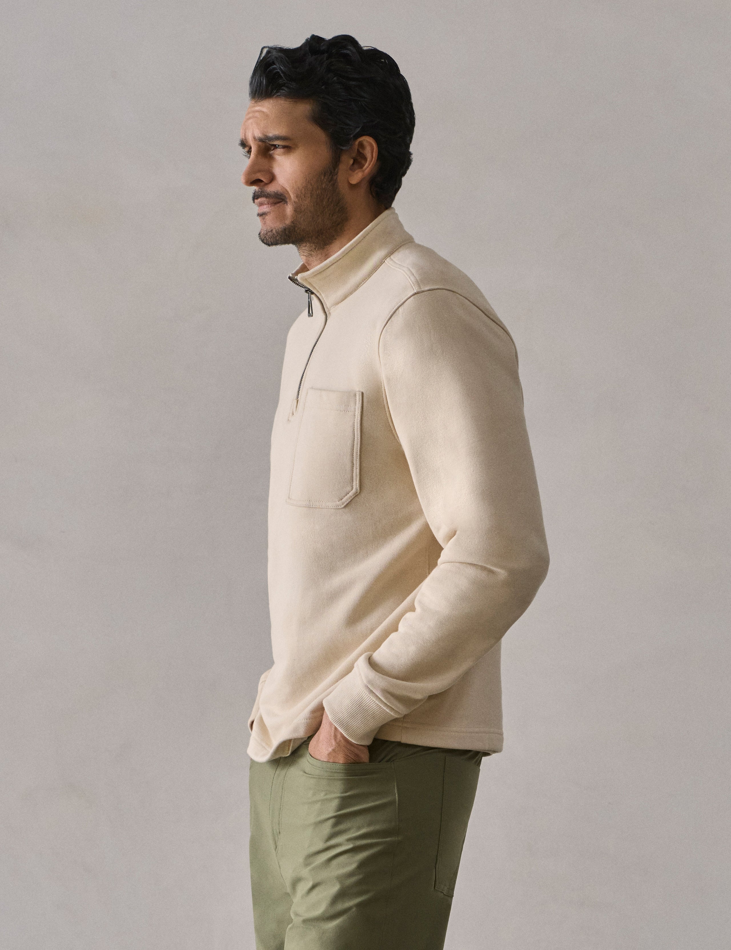 Side profile view of man wearing Monte Half-Zip Sweatshirt in Bone white from AETHER Apparel.