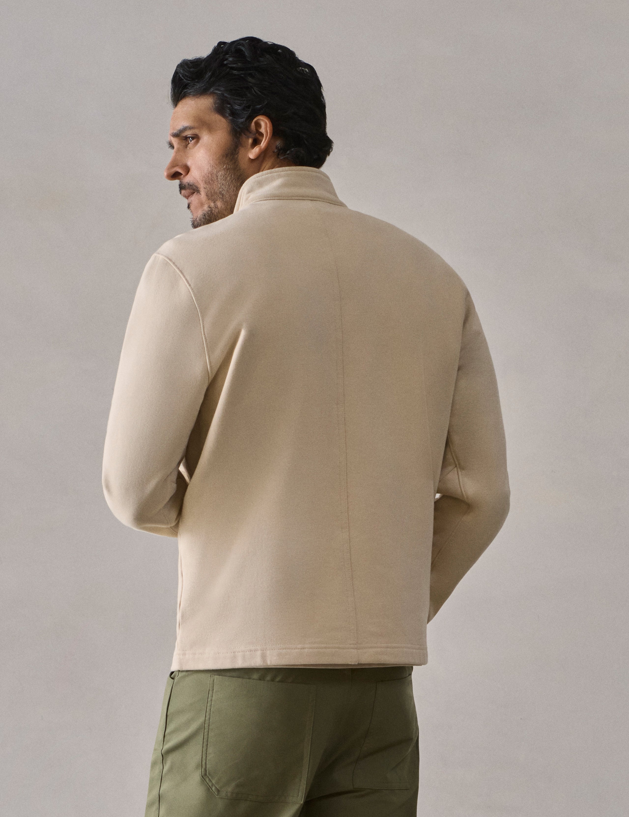 Rear view of man wearing Monte Half-Zip Sweatshirt in Bone white from AETHER Apparel.