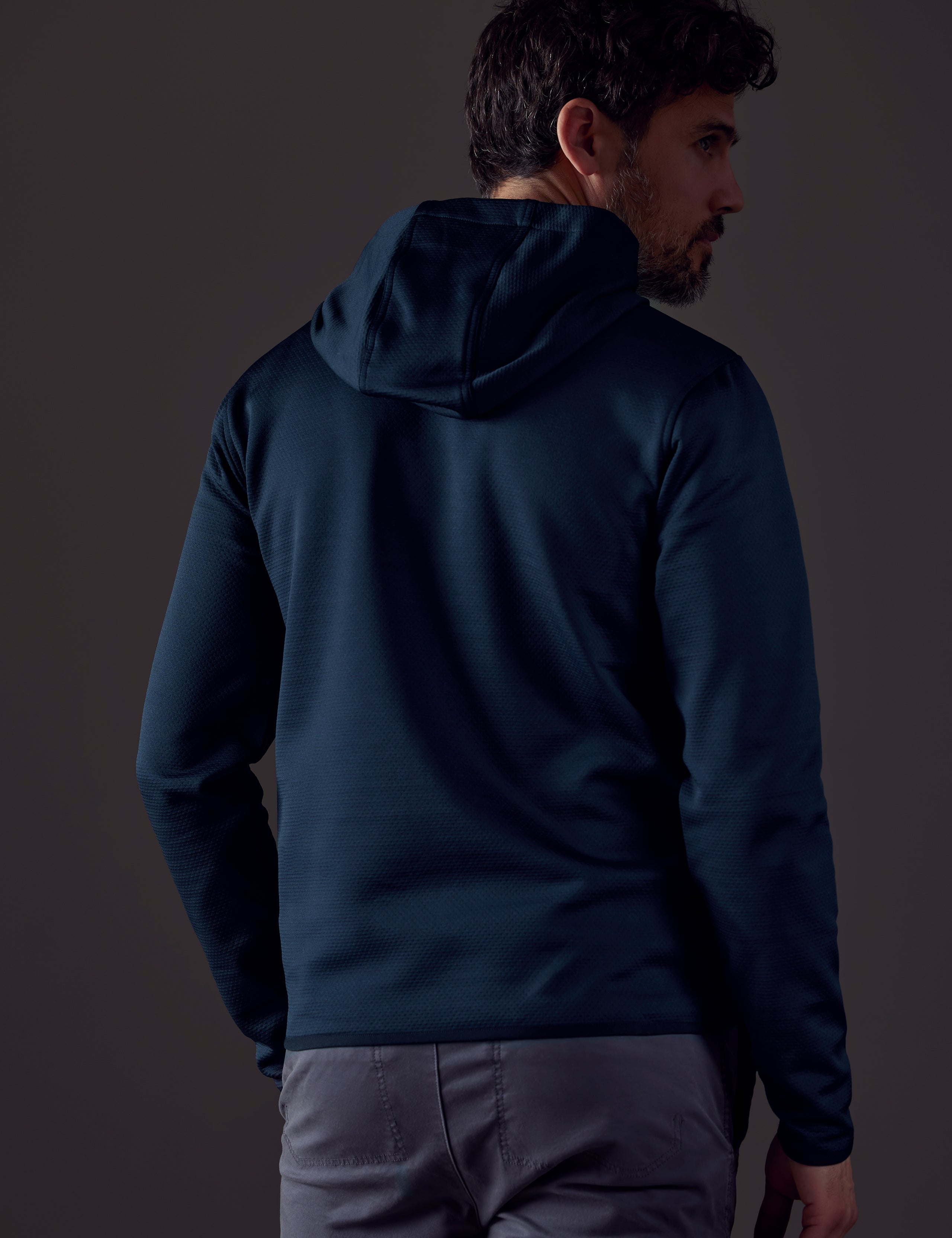 Rear body view of man wearing Morgan Technical Hoodie in Total Eclipse dark blue from AETHER Apparel.