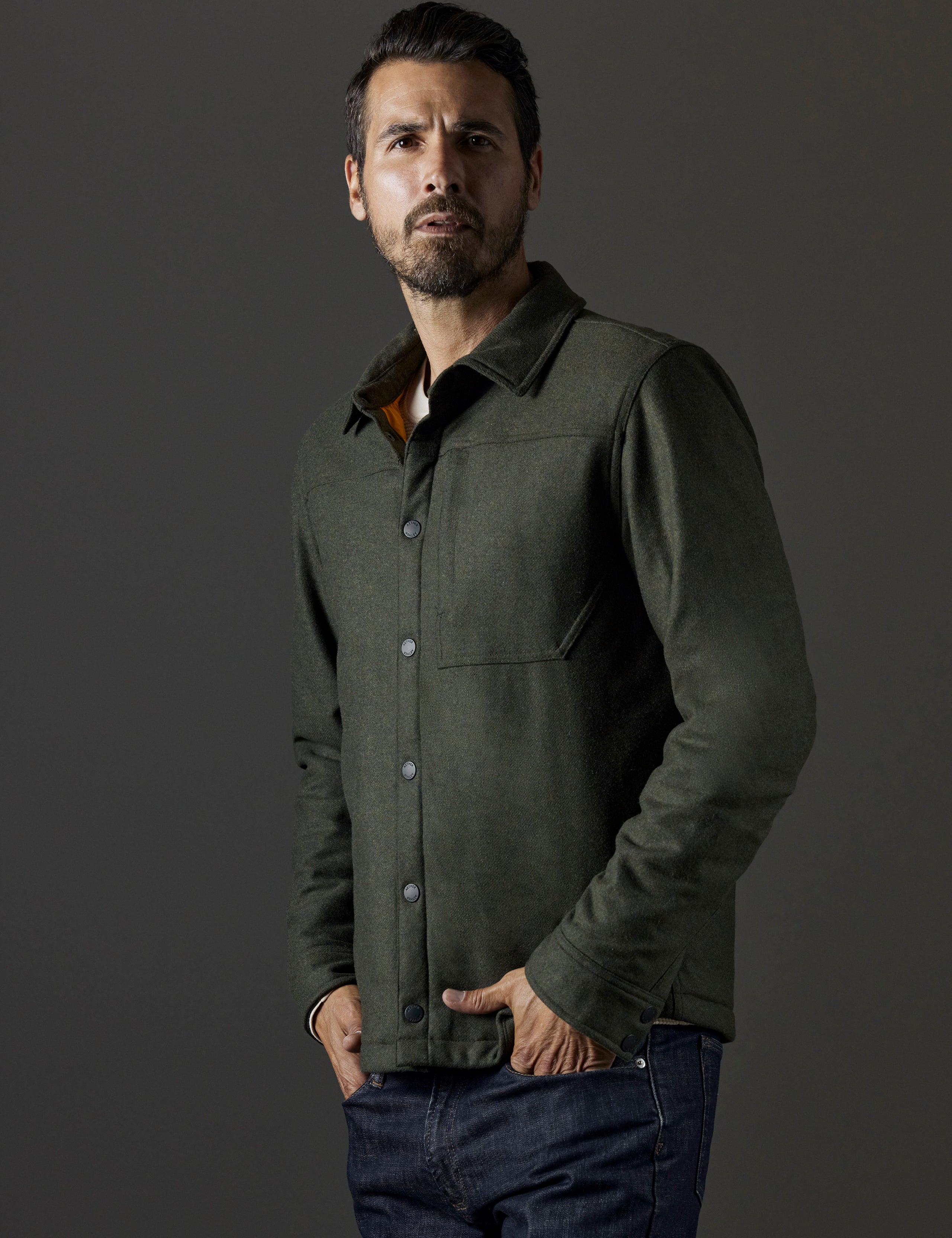Front 3/4 body view of man wearing Nova Insulated Button-Down in Command Green from AETHER Apparel.