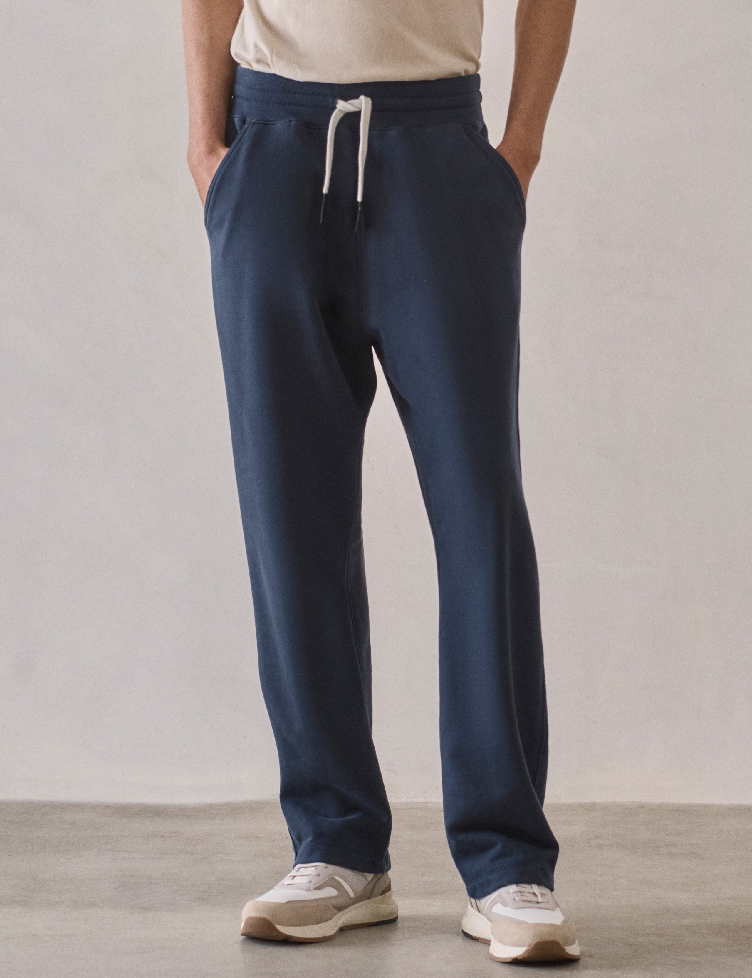 Front lower body view of man wearing Osa Easy-Fit Sweatpant in Total Eclipse dark blue from AETHER Apparel.