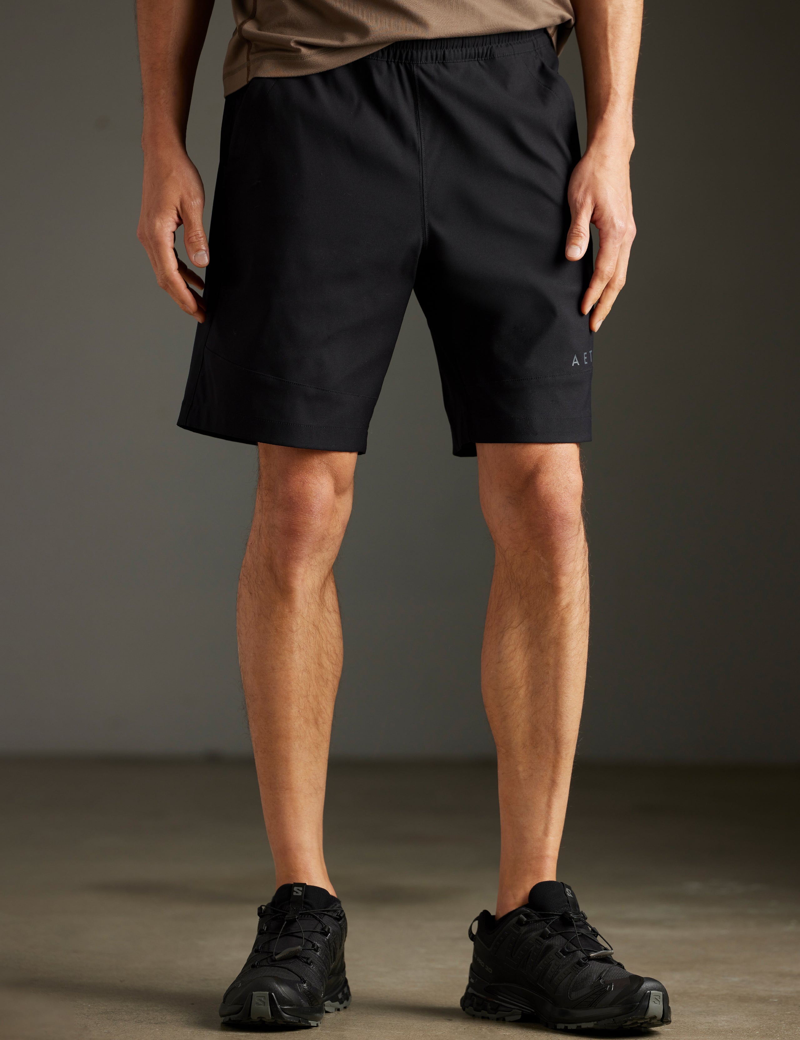 Front lower body view of man wearing Perth Short in Onyx Black from AETHER Apparel.
