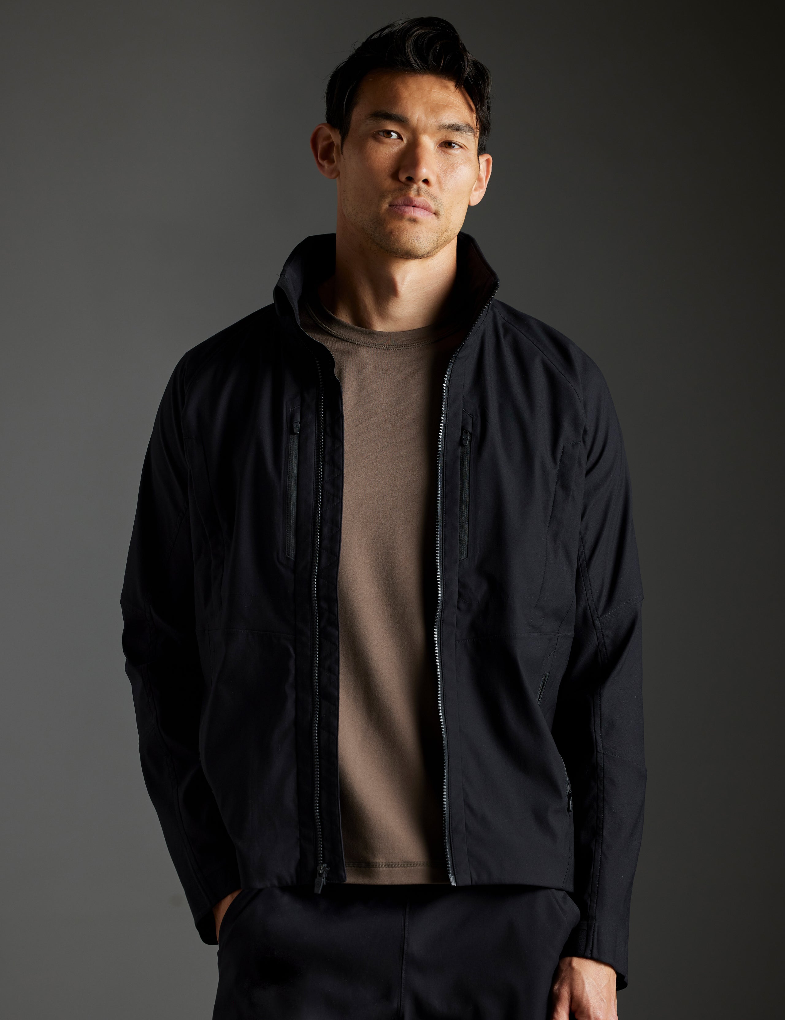 Front body view of man wearing Perth Vented Jacket in Onyx Black from AETHER Apparel.