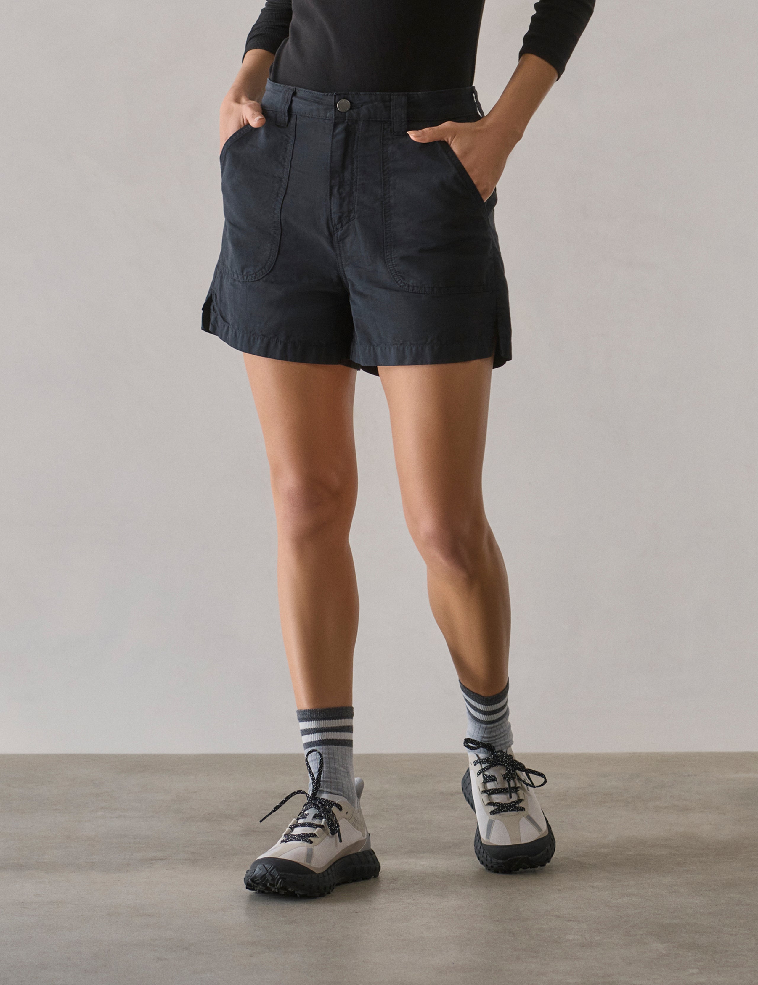 Front lower body view of woman wearing Masai Safari Short in Onyx Black from AETHER Apparel.